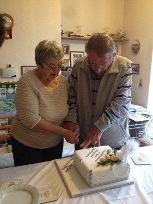 John cutting his Diamond Wedding Anniversary Cake with his wife Sheila.