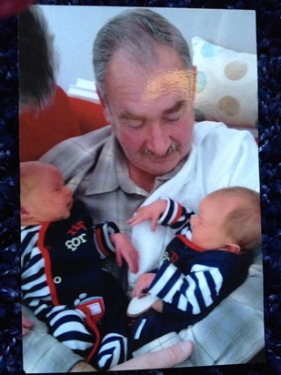 Cuddling his new twin grandsons 2011