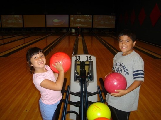 Bowling with his sister Sophia at 9 years old