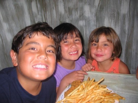 Sharing french fries with his two younger sisters Sophia and Bella