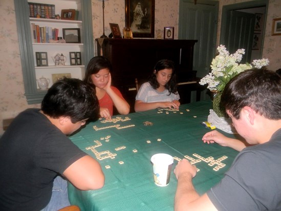 Kids playing banana grams. You can see all the antique pictures in the dining room that sloped down.