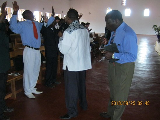 Rev. Edet praying for the participants at the conference