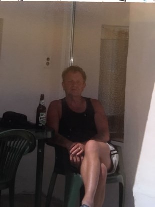 In his favourite spot in Bulgaria having a beer in the shade