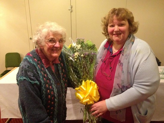 Liz recieveing flowers from ADM at 2014 AGM