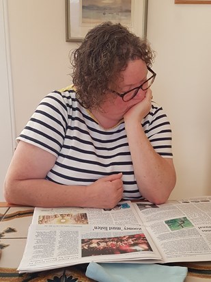 Rae reading the Church Times at Woodbury August 2019