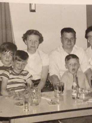 Alan with his brother James, his mum Mary and dad Sam 
