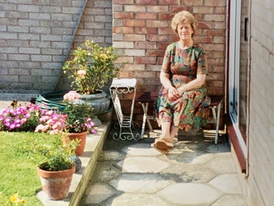 At home in her garden. 