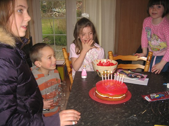 Singing Happy Birthday to Hannah after they'd all made a decorated the cake