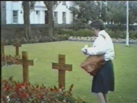 jersey park Olive putting flowers on unknown sailors grave in memory of brother Ernie  killed 1943 