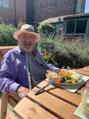 Mike enjoying his lunch during a sunny day in the garden in 2020.