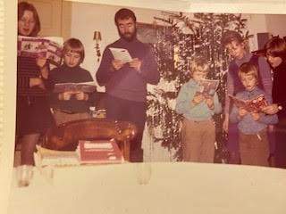 A rare picture of all seven of us singing carols at grandparents' house in Germany