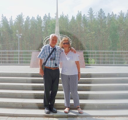 a "transcontinental" embrace on the Asia-Europe (Азия-Европа) border in the Urals