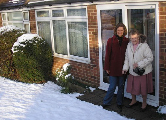 Thelma outside her home with her Mum, 2010