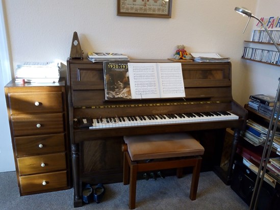 Her glasses are on the keyboard where she left them, her special piano-playing shoes placed neatly side by side, book on the stand open at the last piece she played. But there is no one to play the piano now. 