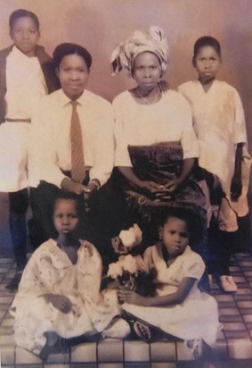 The young Emmanuel (bottom left) with siblings and his mother