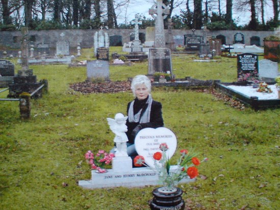 Angela beside Pauls grave