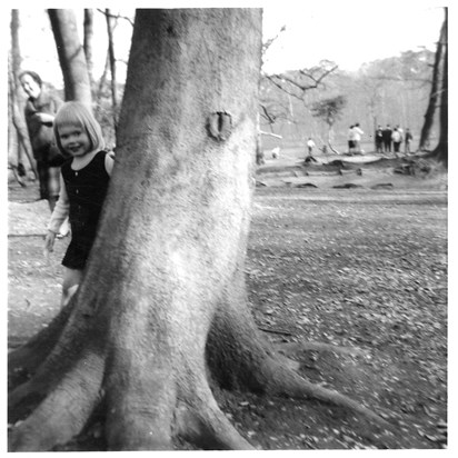 Sarah with her Grandmother Kathleen in the background, peeping around a tree :)