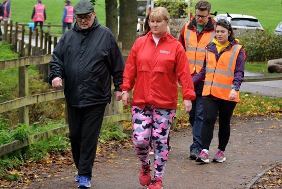 Pete walking a lap of Arrow Valley parkrun with Clare, October 2022. 