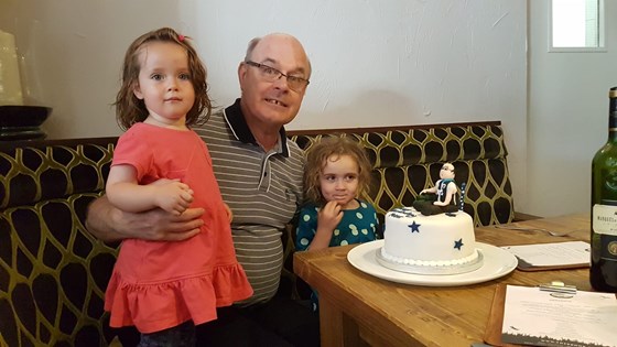 Celebrating his 68th birthday with his granddaughters and a fabulous cake