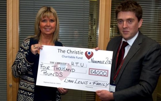 Presenting the cheque to H.T.U. at The Christie