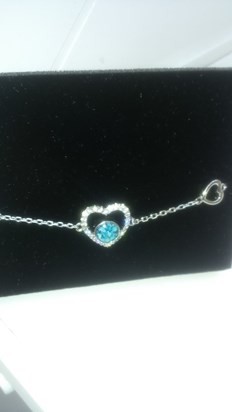 My beautiful braclet that has your ashes in the blue stone and a sprinkle of diamond dust.