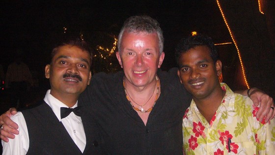 Pete and 2 of our favourite waiters in India. (they took us to the "banana festival"