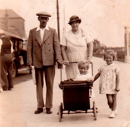 With his dad, mum & sister Vera