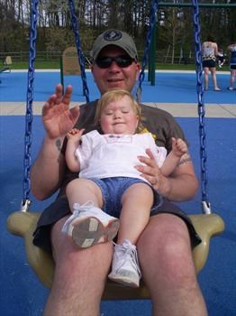 Kathryn and Daddy swinging at the park