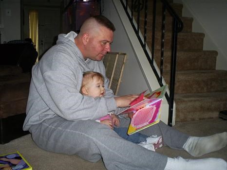Reading to his little girl