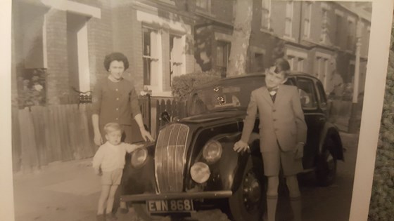 Dennis with Mark and Mum, and our old Austin car