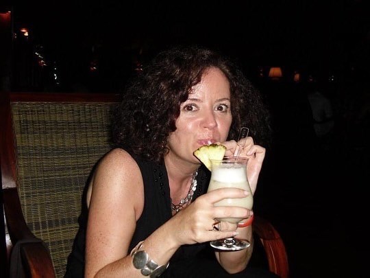 Carol enjoying a cheeky drink in the Maldives
