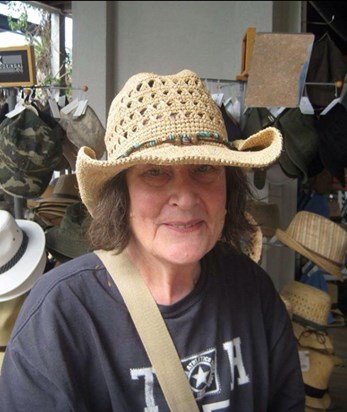 Carole trying on hats in Brisbane 