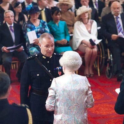 Receiving his MBE