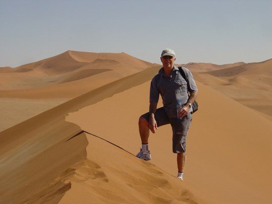 Climbing sand dunes in Namibia