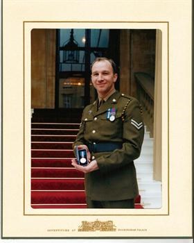 wayne with his queen galantry medal at buckingham palace