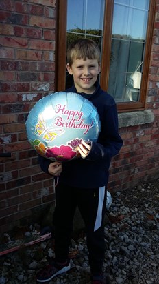 Jack holding Mummy's balloon before he sent it up to Mummy in heaven.