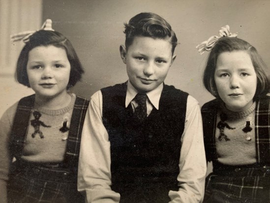 As a boy with his sisters.