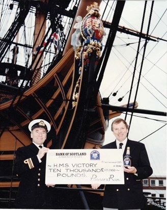Michael presenting a Pusser's cheque on HMS Victory 1993
