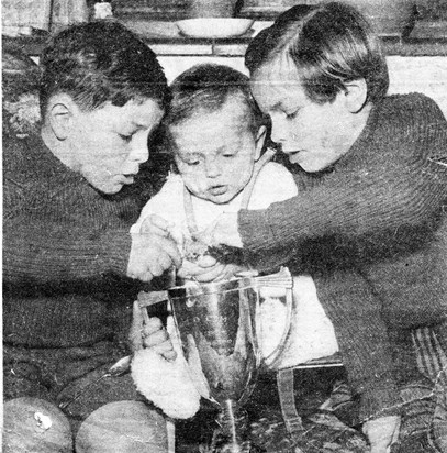 Neil (centre) at nine months with Gail and Charles