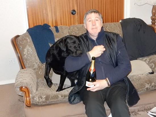 Andy's 60th birthday: teasing our beautiful black lab, Boss, with dog treats hidden in his right hand!