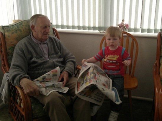 Teaching great grandchildren to read the newspaper....