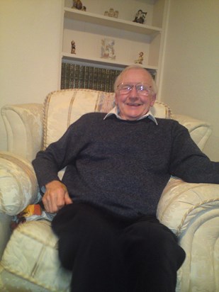 Dad laughing in armchair