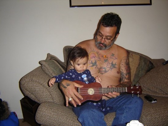 Tristan playing guitar with his Poppa