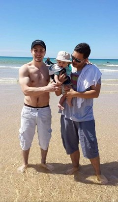 Vinnys first time going in the sea, with his uncle Tel dipping him in.