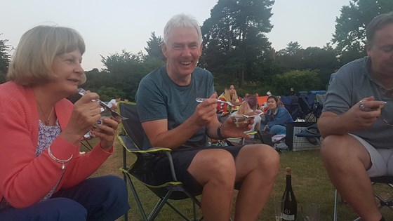 Laughing at the open air cinema.  Thankfully his shorts are longer now, James...