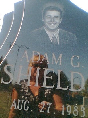 Adam's mother's reflection in his headstone.
