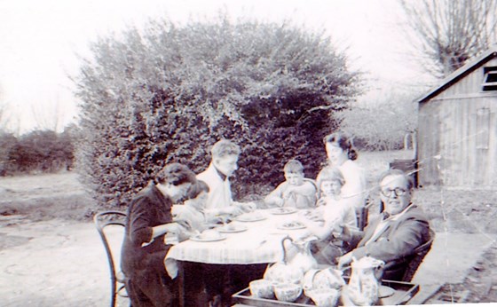 Ian, and Ruth with Roger, Molly with Kate, Jeremy and Susan in garden eating