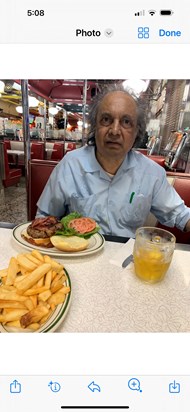 Having his favorite New York burger with a beer