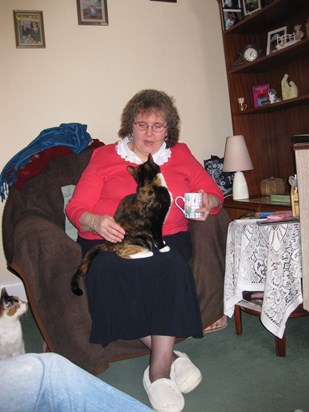 At home with her cuppa and her cats