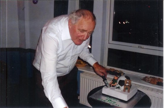 dad cutting cake at 80th 001